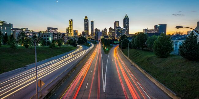 View of highway in long exposure with city in background