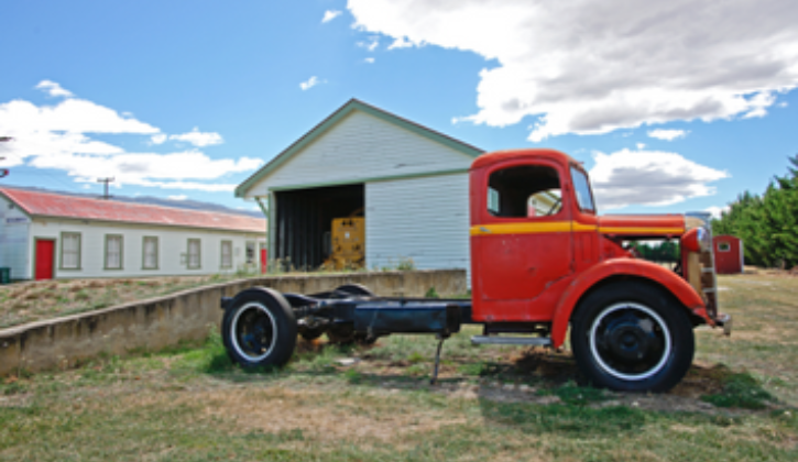 Old red semi tractor with no trailer