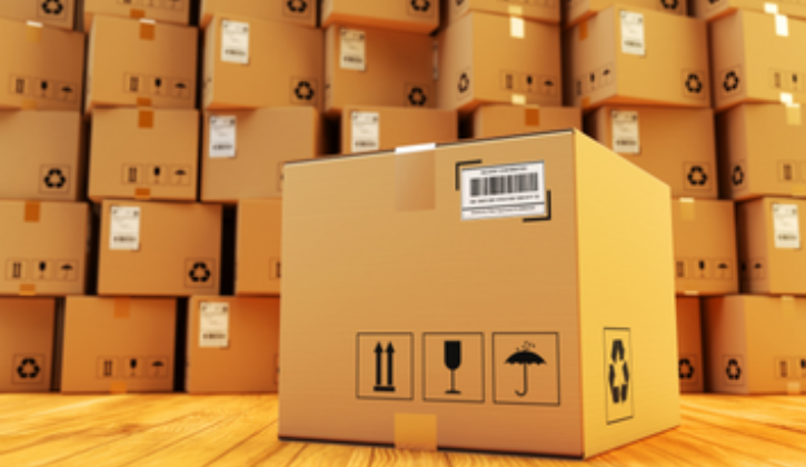 Cardboard box sitting on floor in front of background full of stacked cardboard boxes