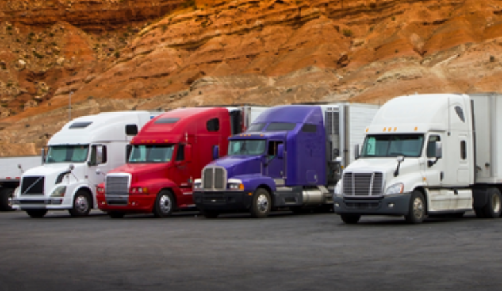 4 class 8 trucks, white, red, indigo, and white in Red Rock County Utah