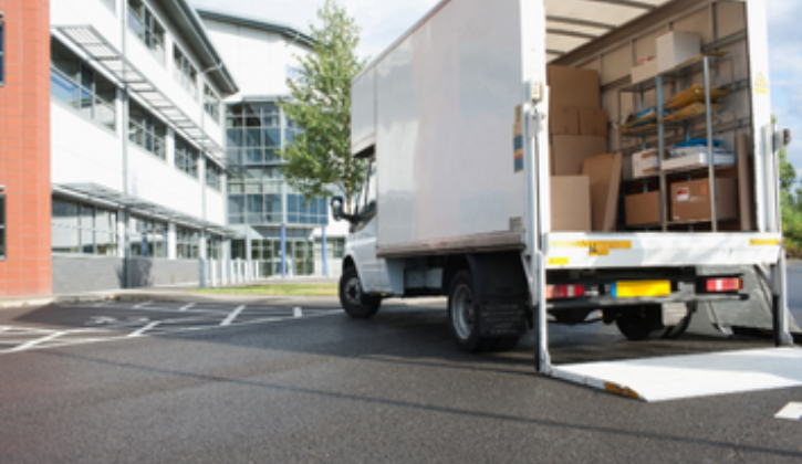 White delivery truck with the liftgate down and back open