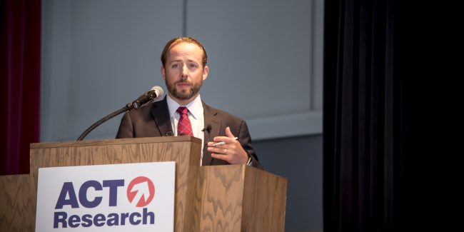 Tim Denoyer Speaking on stage at a seminar at the Commons