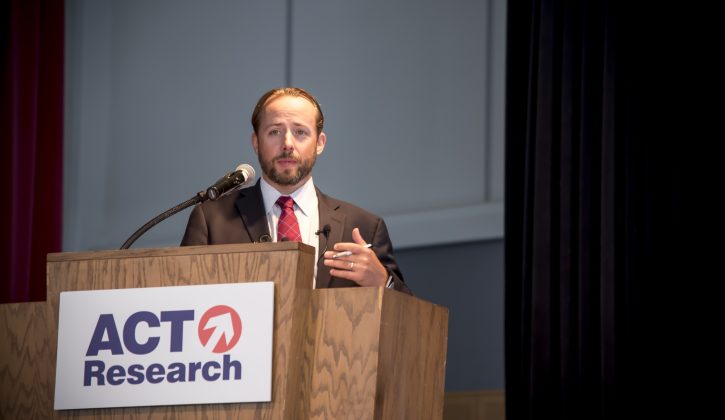 Tim Denoyer Speaking on stage at a seminar at the Commons