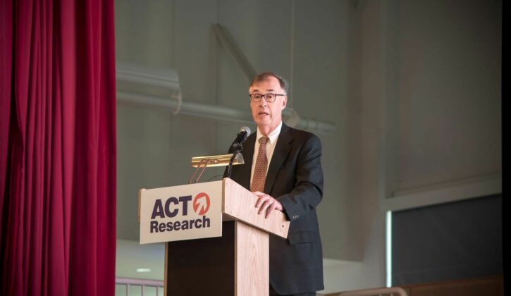 Jim Meal Speaking on stage for a seminar at the Commons